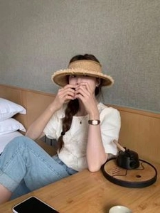 Detailed view of women straw visor hat with wide brim for summer sun protection