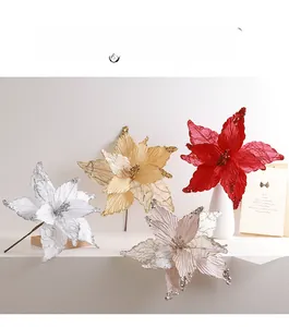 Detailed view of artificial Christmas poinsettia flowers with sequins and glitter mesh texture