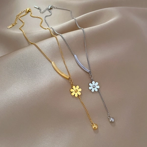 Minimalist titanium steel daisy flower necklace in gold and silver on silk background