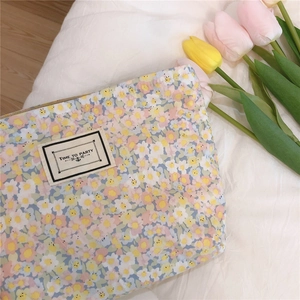 Close-up of floral cotton pouch with small yellow blossoms and Time to Party label