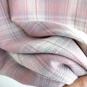 Close-up of pink and white plaid scarf fabric texture showing soft cashmere-like weave