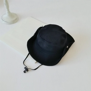 Detail of black outdoor sun hat featuring windproof drawstring and side metal snap button