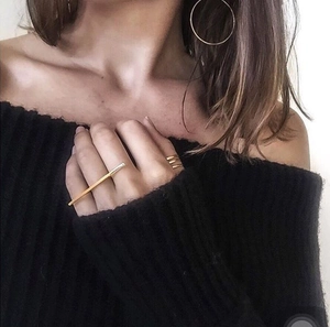 Gold minimalist geometric jewelry set featuring bar ring and hoop earrings on model