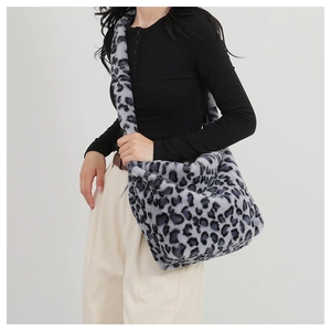 Detail showing plush grey leopard print faux fur texture and wide shoulder strap