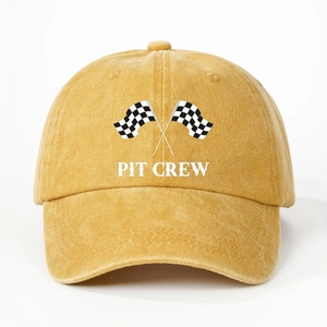 Detailed texture of mustard yellow washed cotton fabric with Pit Crew racing flag print