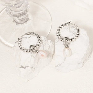 Elegant silver rope twisted hoop earrings with irregular pearl pendants on stone