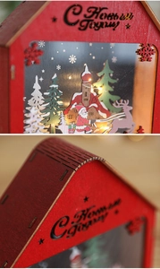 Detail of red wooden Christmas cabin with LED lights and Russian New Year greeting