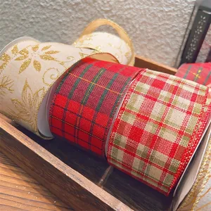 Plaid and floral glitter Christmas ribbon rolls displayed on a rustic wooden tray