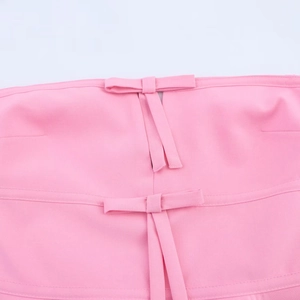 Pink strapless tube top for women featuring front bow details and seamless stitching