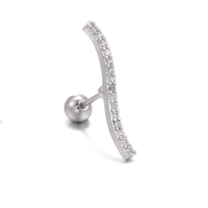 Macro shot of silver curved bar ear stud with sparkling zircon stones and ball backing