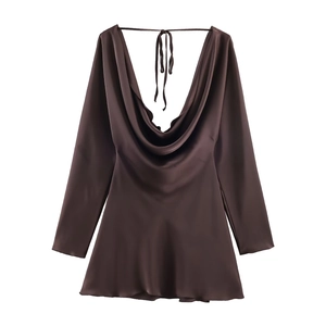 Detail of dark brown satin dress featuring a draped cowl neck and long sleeves