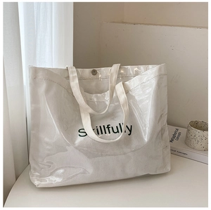 Detail of white double-layer tote bag with PVC outer layer and Skillfully logo