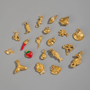 Detailed close-up of 18K gold stainless steel charms in sea and nature shapes