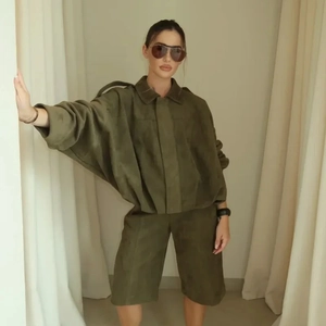 Women's olive green suede flight jacket and shorts set with zipper closure