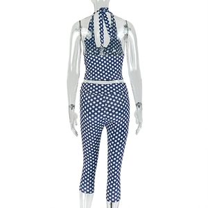 Detail view showing the back of the navy blue polka dot halter top and cropped leggings