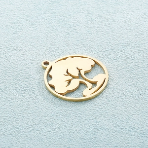 Golden hollow tree of life pendant in stainless steel shown on a blue textured background