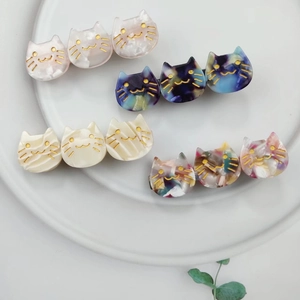 Detail of three-headed acetate cat hair clips in four pastel marble and floral patterns