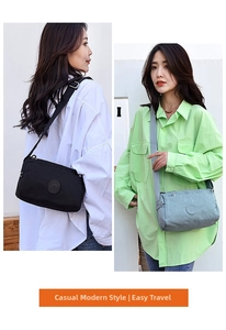 Detail view of nylon crossbody bags in black and light blue with adjustable straps