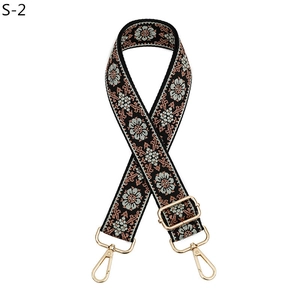 Detail of adjustable ethnic style embroidered bag strap with gold metal lobster clasps