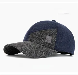 Detail view of navy knit baseball cap with grey tweed panels and leather logo patch