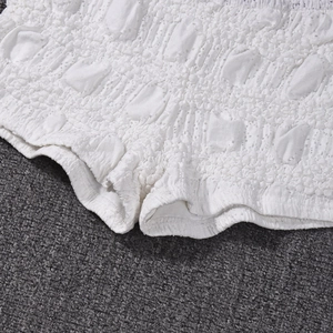 Close-up of white bubble textured fabric on sexy slim fit backless summer shorts
