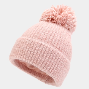 Pink chunky knit beanie with faux fur pom and satin lining for winter warmth