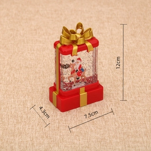 Detailed size view of red Christmas gift box water globe featuring Santa on a reindeer