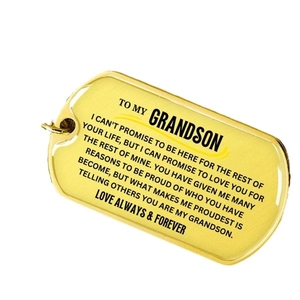 Golden military tag pendant necklace engraved with a message to grandson on white background