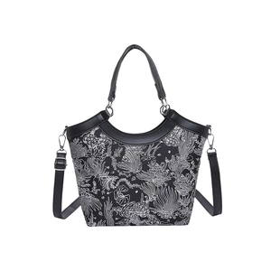 Fashionable bucket bag with black and white floral pattern and adjustable strap