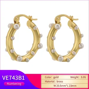 Vintage irregular brass hoop earrings with white faux pearls and gold plating