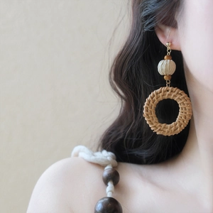 Bohemian style woven rattan hoop earrings with wooden beads for beach vacations