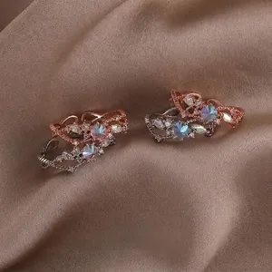 Elegant shell flower open ring with pearls and colorful crystals on brown velvet fabric
