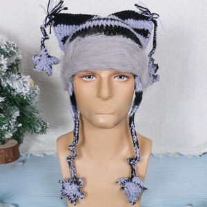 Detail of knit cat ear hat with purple stripes, braided tassels and star charms