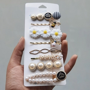 Detail of 8-piece candy-colored hair clip set with pearls, daisies and bee elements