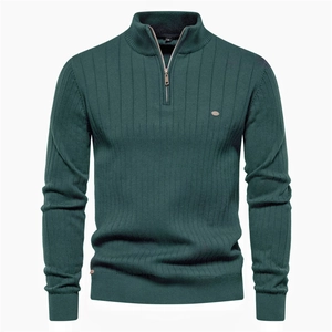 Detail of dark green knit sweater featuring vertical ribbed texture and a half-zip stand collar