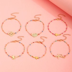 6-piece gold chain bracelet set with colorful beads, heart, cross, and palm tree charms