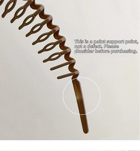Detail view of dark brown wavy headband with non-slip teeth for secure hairstyling