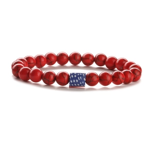 Detail of American flag beaded bracelet with red turquoise beads and blue star cube charm