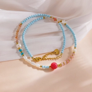 Luxurious multi-material beaded necklace with freshwater pearls, shells and stainless steel