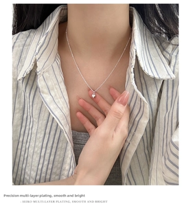 Detailed view of s925 sterling silver heart necklace on neck with polished finish