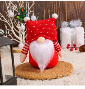 Detailed view of a Christmas gnome doll with a red polka dot hat and white plush beard