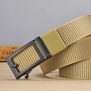 Close-up of khaki nylon belt with black matte buckle on a vintage wooden surface