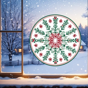 Detail of red and green snowflake mandala static window clings on glass with snowy background
