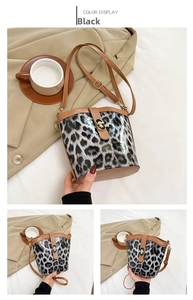 Detail of leopard print bucket bag featuring brown leather trim and golden twist-lock closure