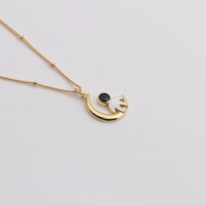 Golden crescent moon necklace with a miniature white astronaut pendant charm accessory