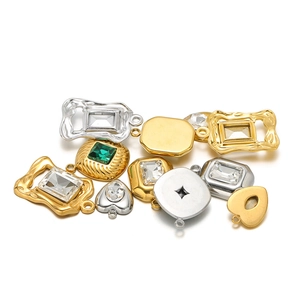 Gold and silver stainless steel pendants with emerald green stones for DIY jewelry