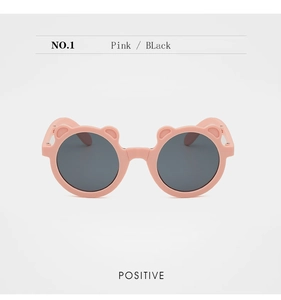 Front view of pink bear-shaped folding sunglasses for kids with dark lenses
