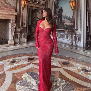Detailed view of sexy red lace long sleeve slim fit maxi dress in an elegant palace