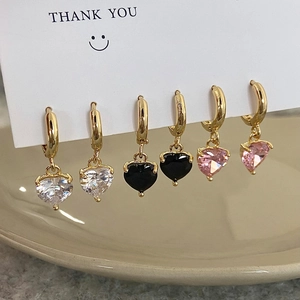 Close-up of heart-shaped zircon drop earrings in clear, black, and pink colors