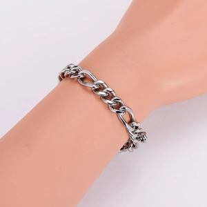 Classic 8mm silver stainless steel Figaro chain bracelet worn on a wrist over white background